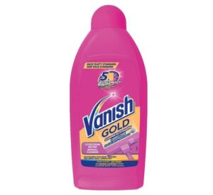 The image shows a bright pink bottle of Vanish Gold Carpet Care liquid detergent. The label at the top reads "NASZ ZŁOTY STANDARD" (Our Gold Standard) and features a "5x SKUTECZNIEJSZY" (5x More Effective) benefits badge. The Vanish logo is prominently displayed in blue, white, and pink, with "GOLD" written below it in gold text. Below this, it says "SZAMPON DO DYWANÓW" (Carpet Shampoo) and "CARPET CARE." The label also highlights "Czyszczenie Ręczne" (Manual Cleaning) and an image of a carpet cleaning tool. The bottom of the label promises "FOR NEWER-LOOKING CARPETS" and mentions "Manual Cleaning" in English as well. The overall design emphasizes its superior cleaning effectiveness and ease of use.